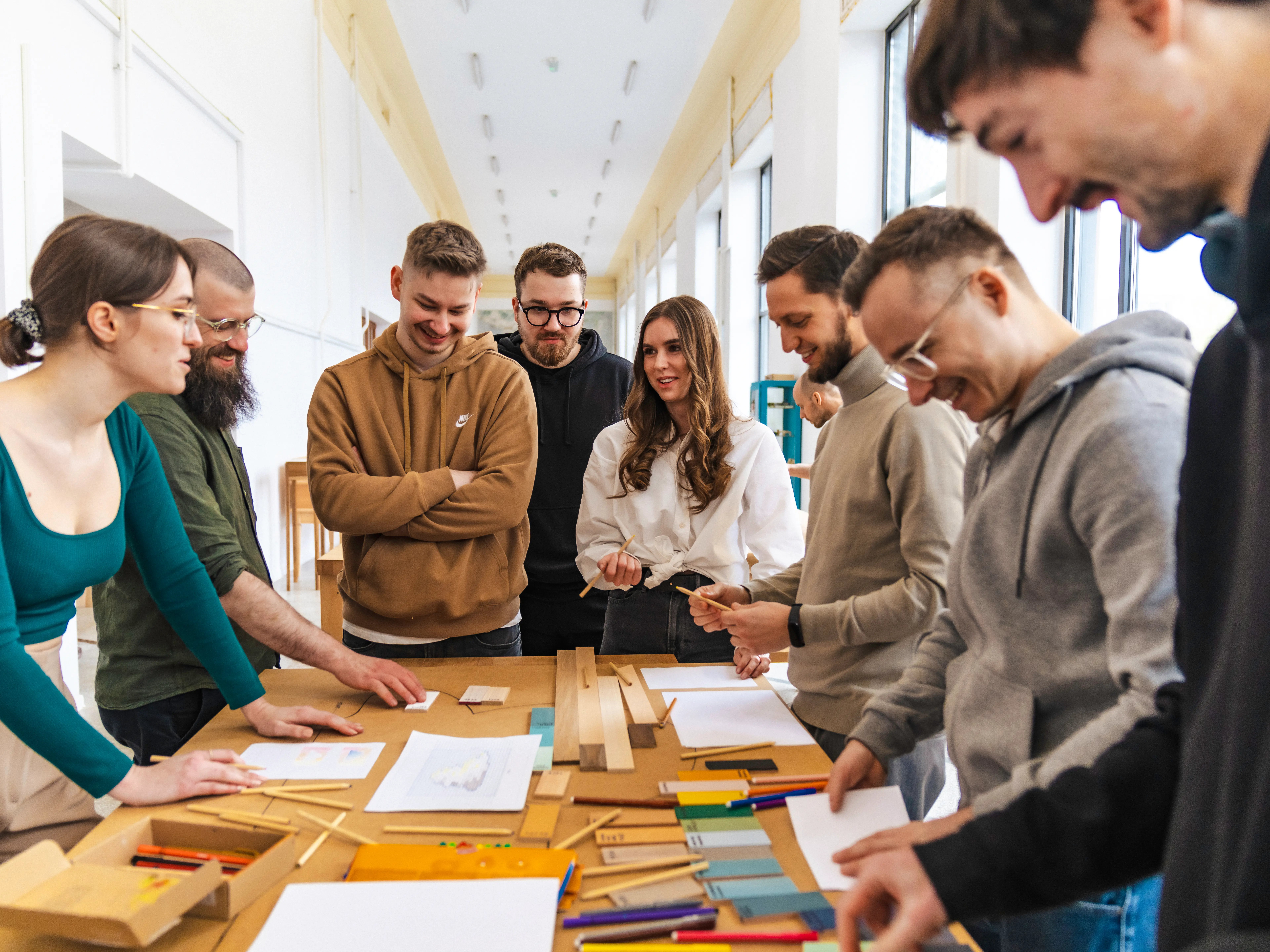 Design Team at a woodwork table preparing different materials